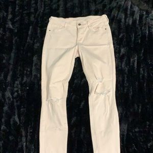 Pale pink distressed skinny jeans